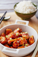 Baked chicken sesame on a bamboo chopping board with basmati rice