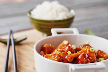 Baked chicken sesame on a bamboo chopping board with basmati rice