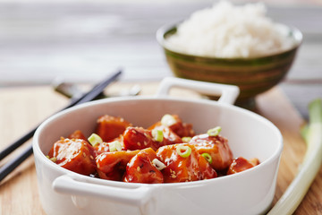 Baked chicken sesame on a bamboo chopping board with basmati rice