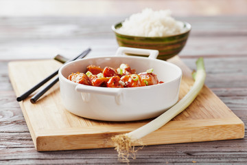 Baked chicken sesame on a bamboo chopping board with basmati rice