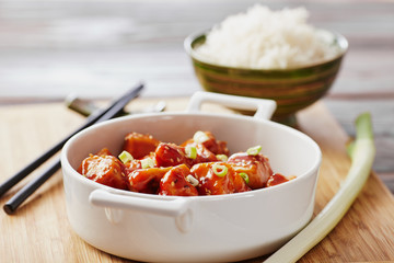 Baked chicken sesame on a bamboo chopping board with basmati rice