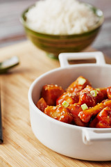 Baked chicken sesame on a bamboo chopping board with basmati rice