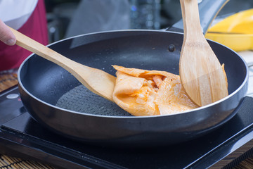 Chef cooking Pad Thai wraped wuth egg