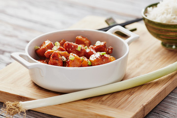 Baked chicken sesame on a bamboo chopping board with basmati rice