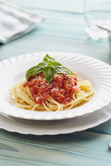 spaghetti amatriciana on a blue wooden table (Italian dish)