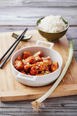 Baked chicken sesame on a bamboo chopping board with basmati rice