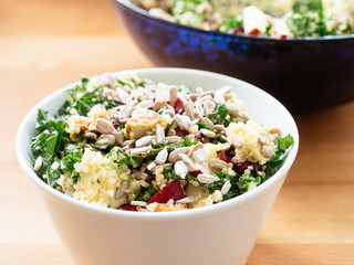 Quinoa kale salad with cranberries, apple, avocado, tofu and sunflower seeds