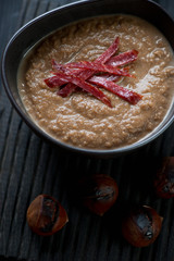 Close-up of chestnut cream-soup with smoked meat topping