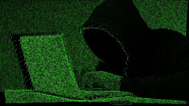 Anonymous hacker in black hood with a laptop