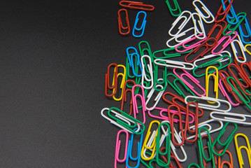 Colorful Paper clips isolated on black background.