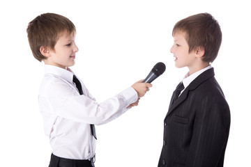 cute little boy reporter with microphone taking interview isolat