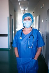 Portrait of surgeon standing with hand in pocket
