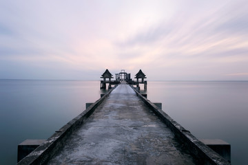Fototapeta premium Landscape of Wooded bridge in the port between sunrise