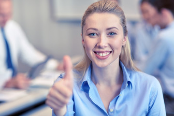 group of smiling businesspeople meeting in office