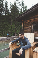 Man sit on a wood chair at braies lake - 121566428