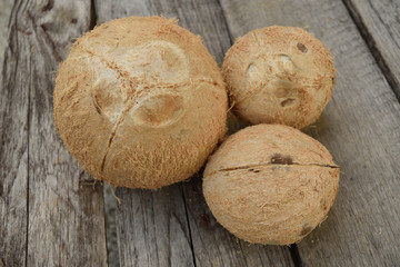 several coconuts on a wooden background