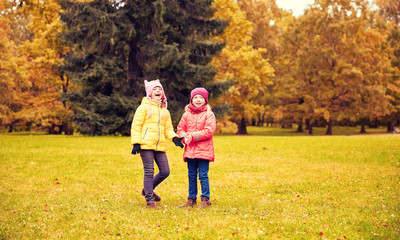 Fototapeta premium two happy little girls in autumn park
