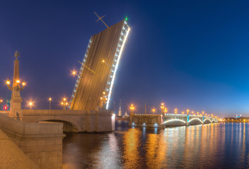 Fototapeta na wymiar Night view of illumunated open Trinity Bridge and Neva River, St. Petersburg, Russia.