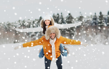 Fototapeta na wymiar happy couple having fun over winter background