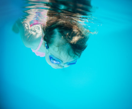 In the deep - girl swimming underwater