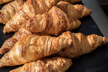 Croissants bed on a black plate