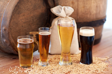 close up of beer barrel, glasses and bag with malt