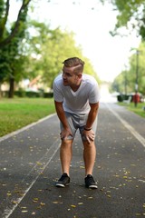 Fototapeta premium Blonde attractive man resting after jogging
