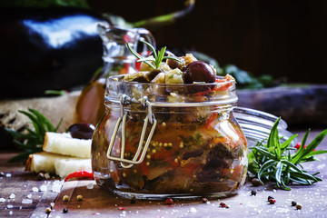 Homemade Eggplant Caponata with black olives in a glass jar, vin