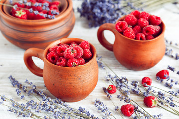 pottery with raspberries and lavender on wooden table