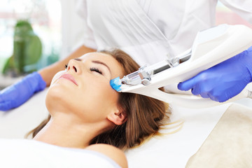 Woman having facial mesotherapy in beauty salon