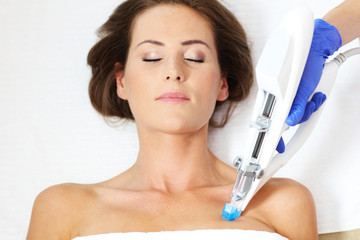 Woman having breast mesotherapy in beauty salon
