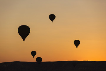 Silhouettes of balloon over sunrise in Cappadocia, Turkye