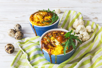 Italian cauliflower with quail eggs, arugula and spices