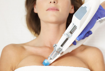 Woman having breast mesotherapy in beauty salon