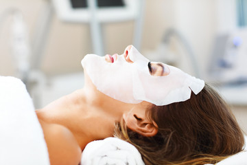 Woman with facial mask in beauty salon