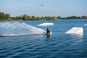 young man on wakeboard is ready to jump