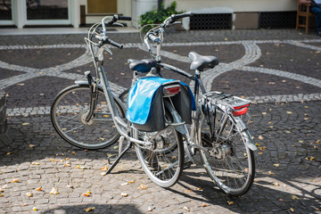 Fototapeta na wymiar two bycicles standing on the street in the sun