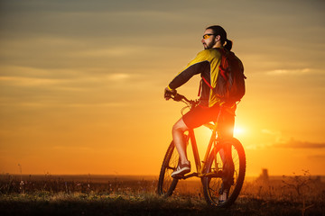 Man in helmet and glasses stay on the bicycle