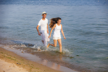 Couple running on a sandy beach