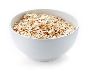 Bowl of oat flakes isolated on white