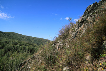 Obraz premium Abrupt stony slope on a background of the blue sky