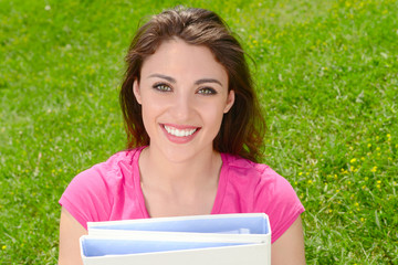 student in park with folders