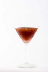 Ice brown alcohol cocktail beverage in martini glass on white background