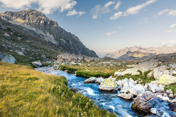 Fototapeta na wymiar Tourists pass Uchkulan. Mountain landscape. Mountain river