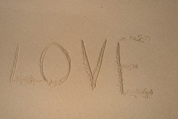 Love in the sand with stone heart.