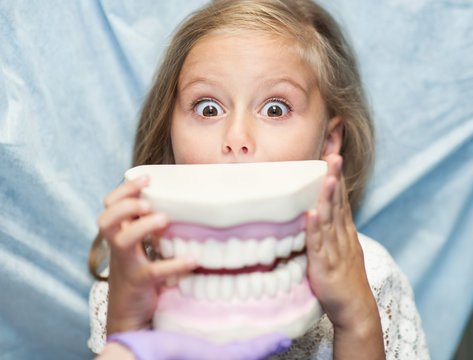 Dentist Curing A Child Patient In The Dental Office In A Pleasant Environment. There Are Specialized Equipment To Treat All Types Of Dental Diseases In The Office.