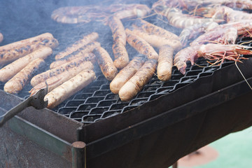 cooked wurstel on top a barbeque