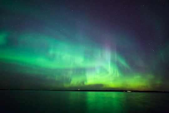 Northern lights over lake in finland