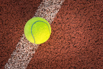 Close up of tennis ball on clay court./Tennis ball