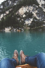 View of feet and lake from a wood boat at Braies lake
- 121582025